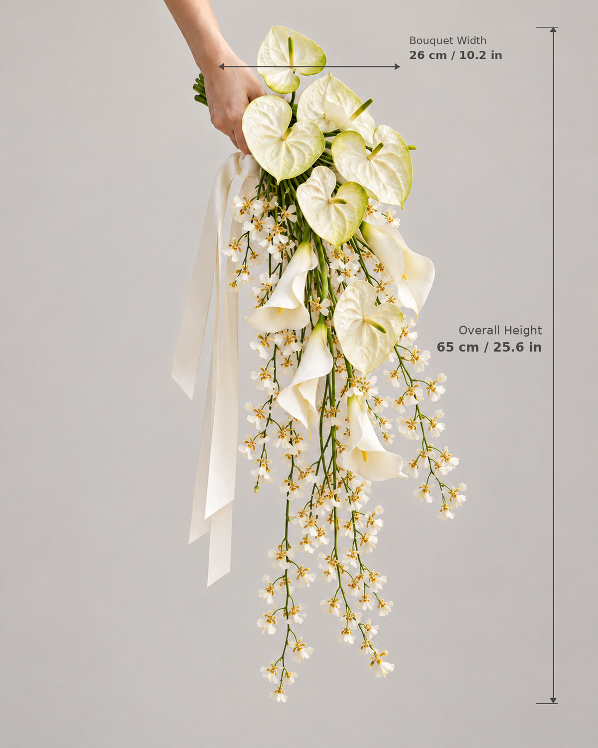 White Oncidium Cascade bridal bouquet dimension guide showing overall height 65 cm (25.6 in) and width 26 cm (10.2 in).