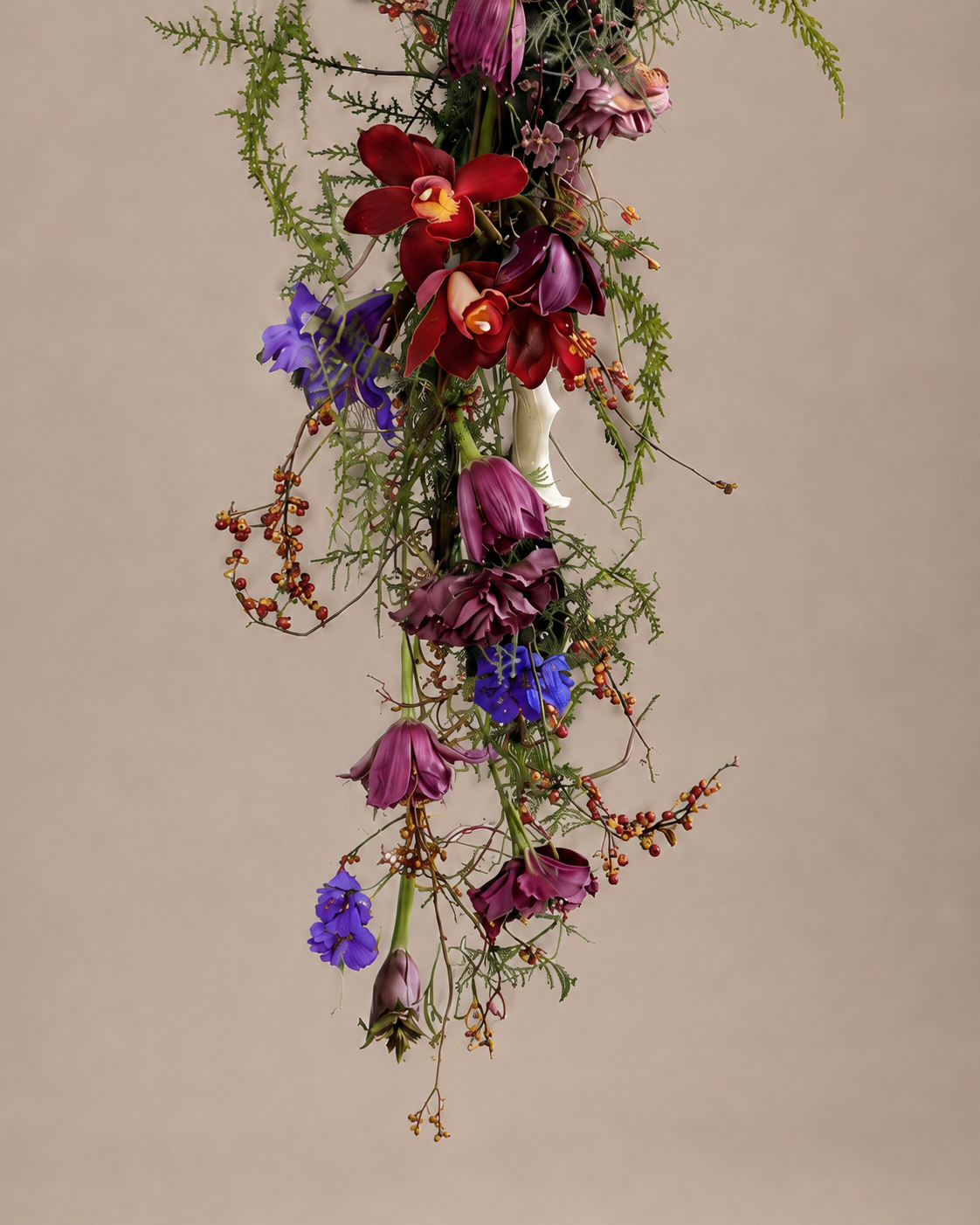 Close-up detail of burgundy cymbidium orchid, tulip, and trailing berries in the lower cascade