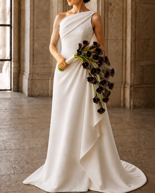 Bride holding Noir Calla black calla lily bridal bouquet, one-shoulder gown editorial shot