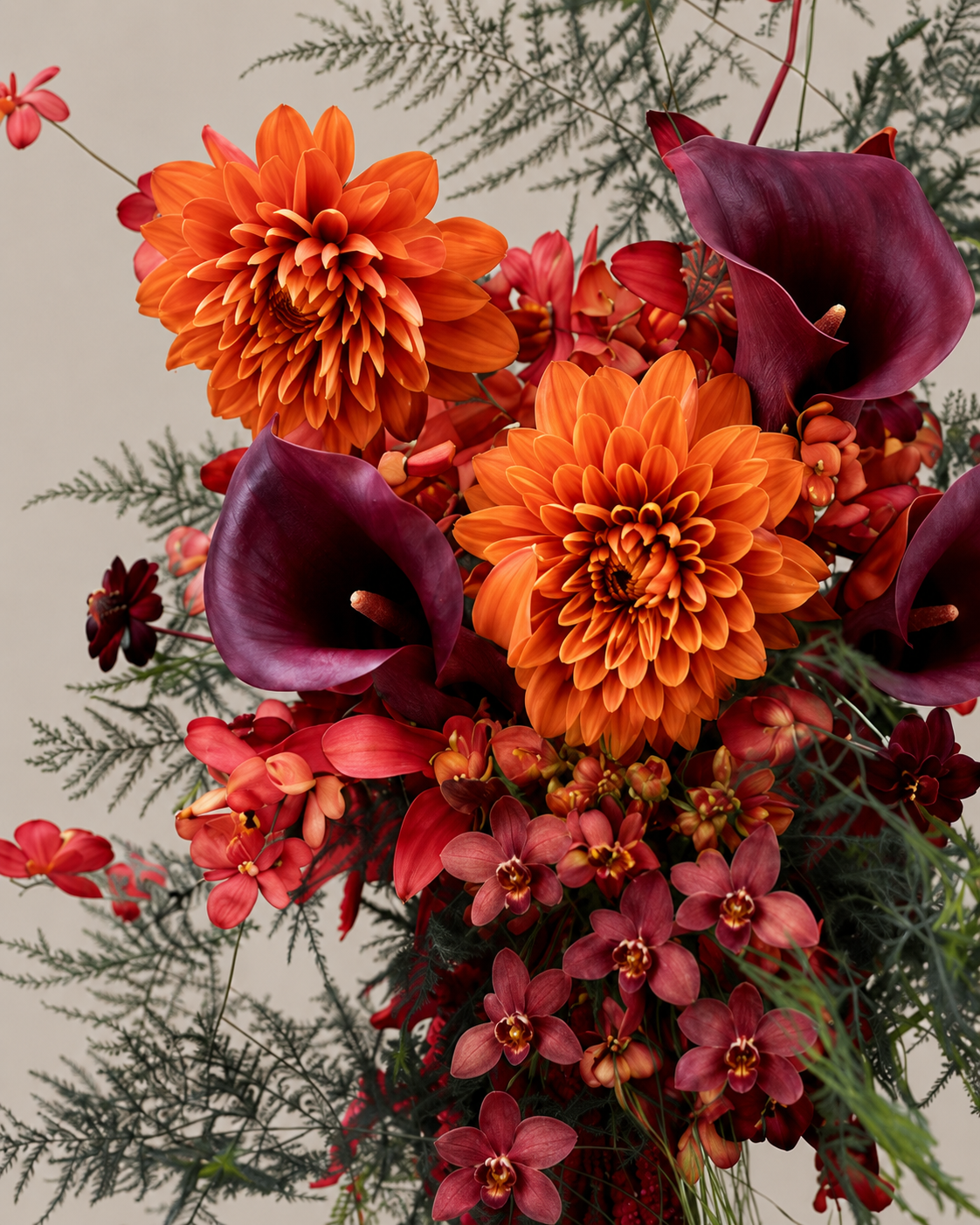 Detail of burnt orange dahlia and burgundy calla blooms in the Ember Cascade bouquet