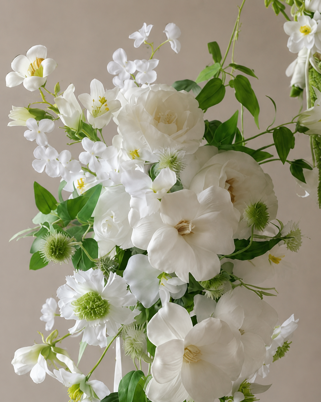 Close-up detail of the Verdant Trail bouquet showing white garden rose and trailing vine foliage